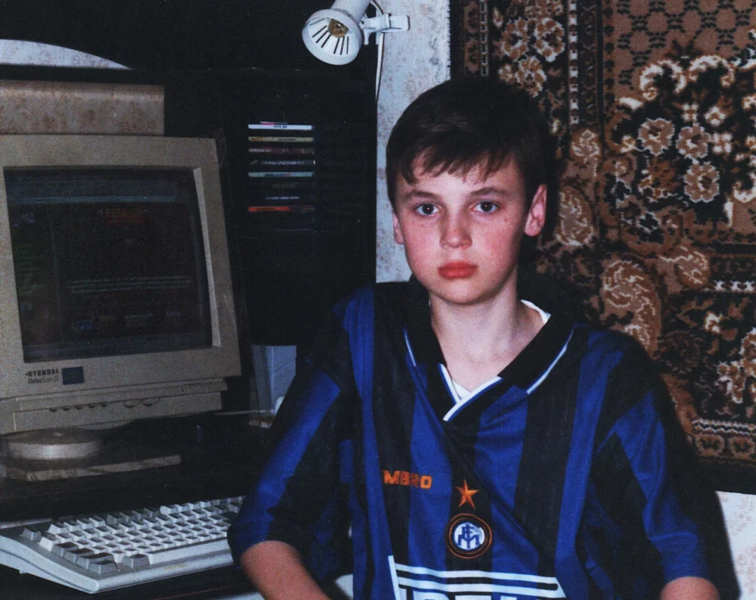 Young Den next to his PC and first website